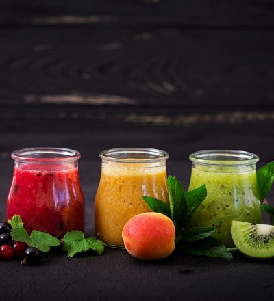 Fresh healthy smoothies from different berries on a dark background. Diet menu. Proper nutrition.