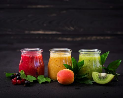 Fresh healthy smoothies from different berries on a dark background. Diet menu. Proper nutrition.